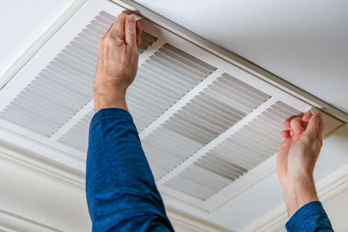 a person's hands holding a vent afeter the best duct cleaning service