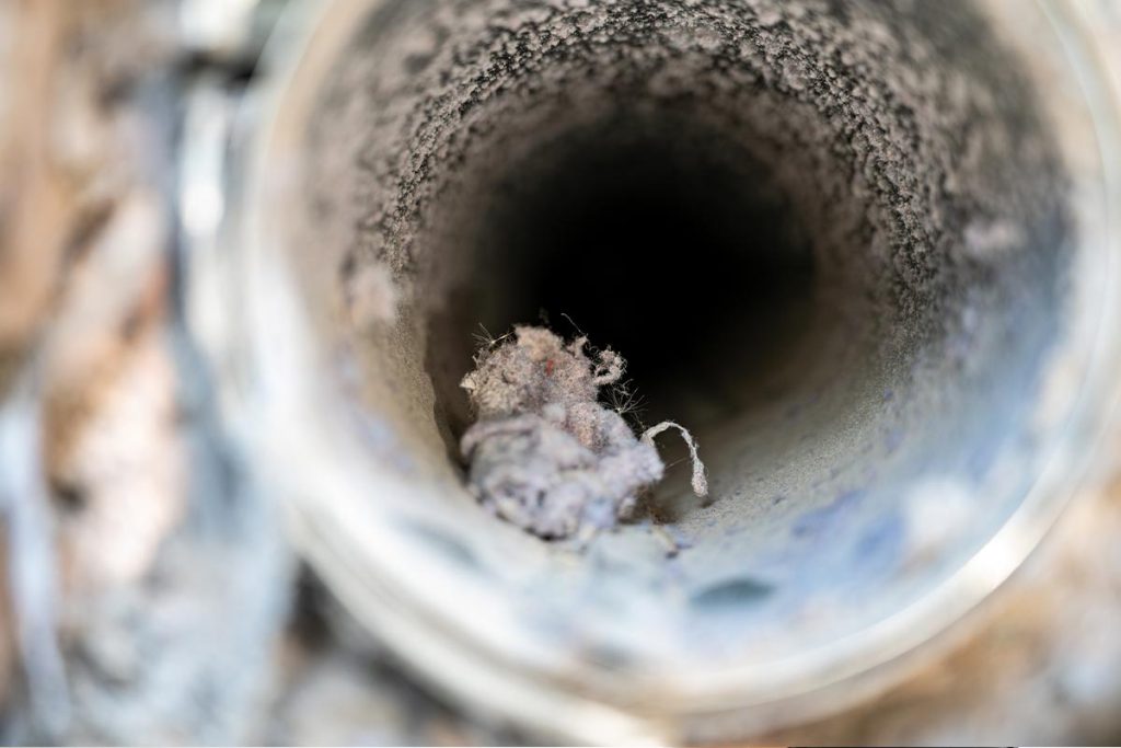 Lint ball in a air duct showing one of the signs of dirty ducts