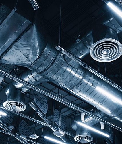 Metal supply ducts and diffusers in a ceiling